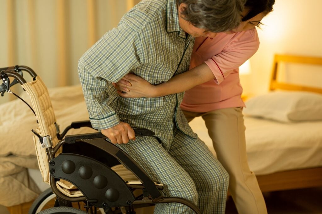Senior man being cared by a female caregiver